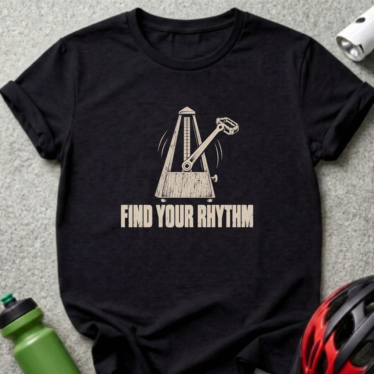 A black t-shirt printed with a metronome graphic and the text Find Your Rhythm.