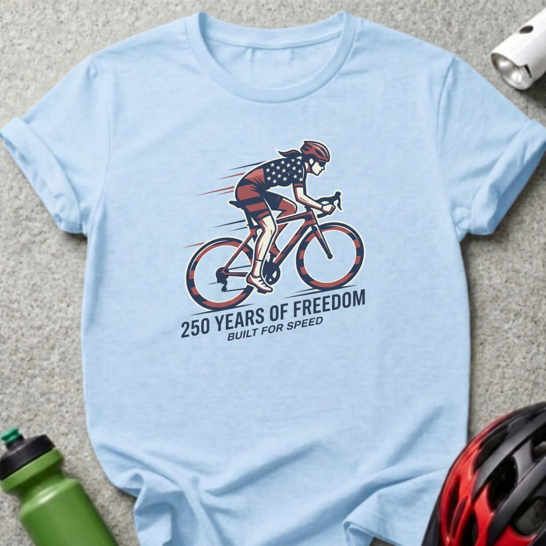 Light blue t-shirt with cyclist graphic and "250 Years of Freedom Built for Speed".