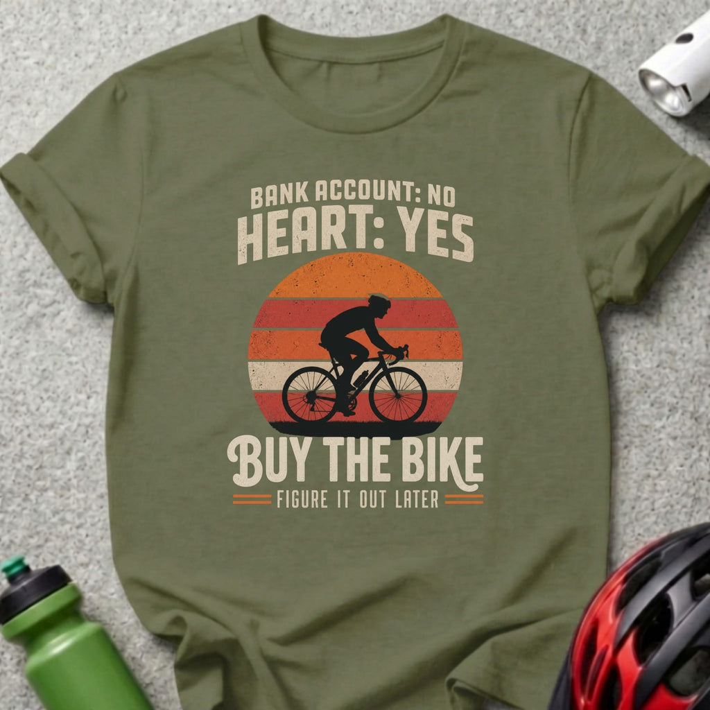 Olive green t-shirt with cyclist graphic and "Bank Account: No Heart: Yes Buy the Bike" text.