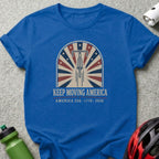 Blue t-shirt with "Keep Moving America" and bicycle wheel design.