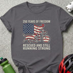 Dark grey t-shirt with American flag, cyclist, and dog graphic and text.