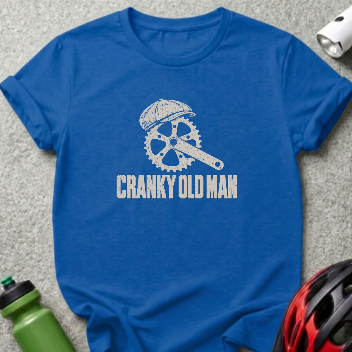 Royal blue t-shirt featuring a white graphic of a bicycle crankset wearing a cap with the text Cranky Old Man.
