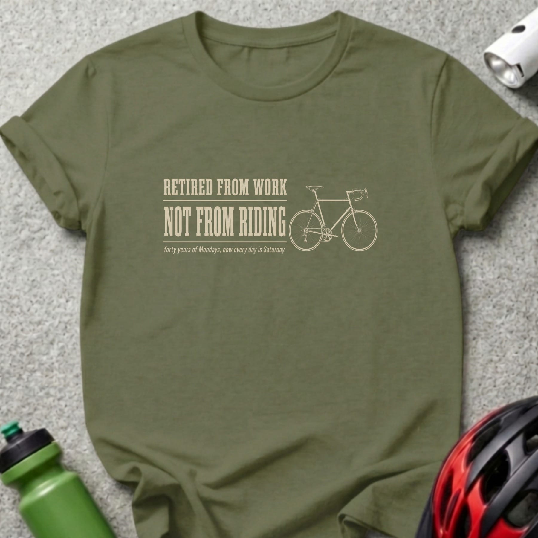 Olive green t-shirt with "Retired From Work, Not From Riding" text and bicycle graphic.
