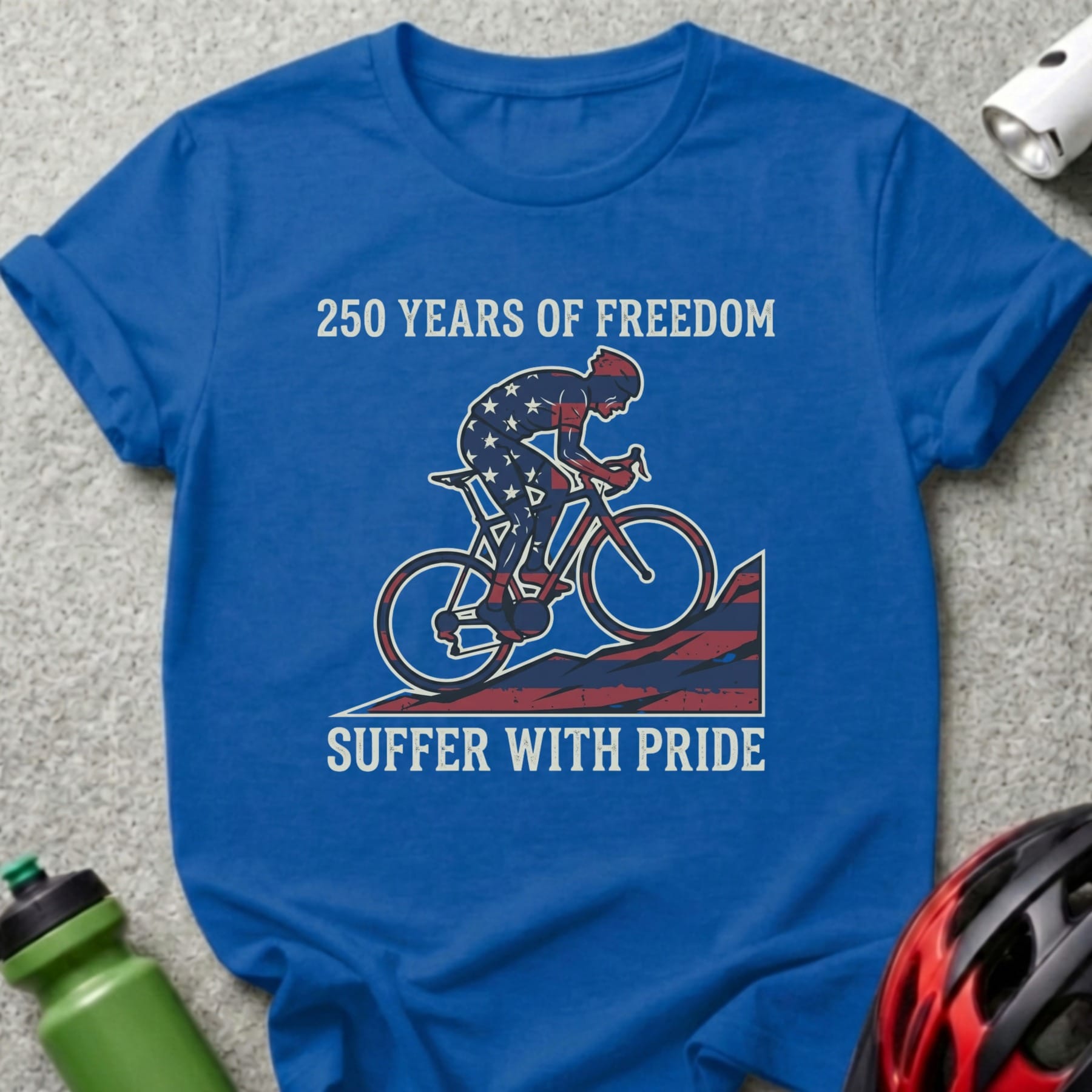 Blue t-shirt with cyclist graphic and text "250 Years of Freedom Suffer with Pride."