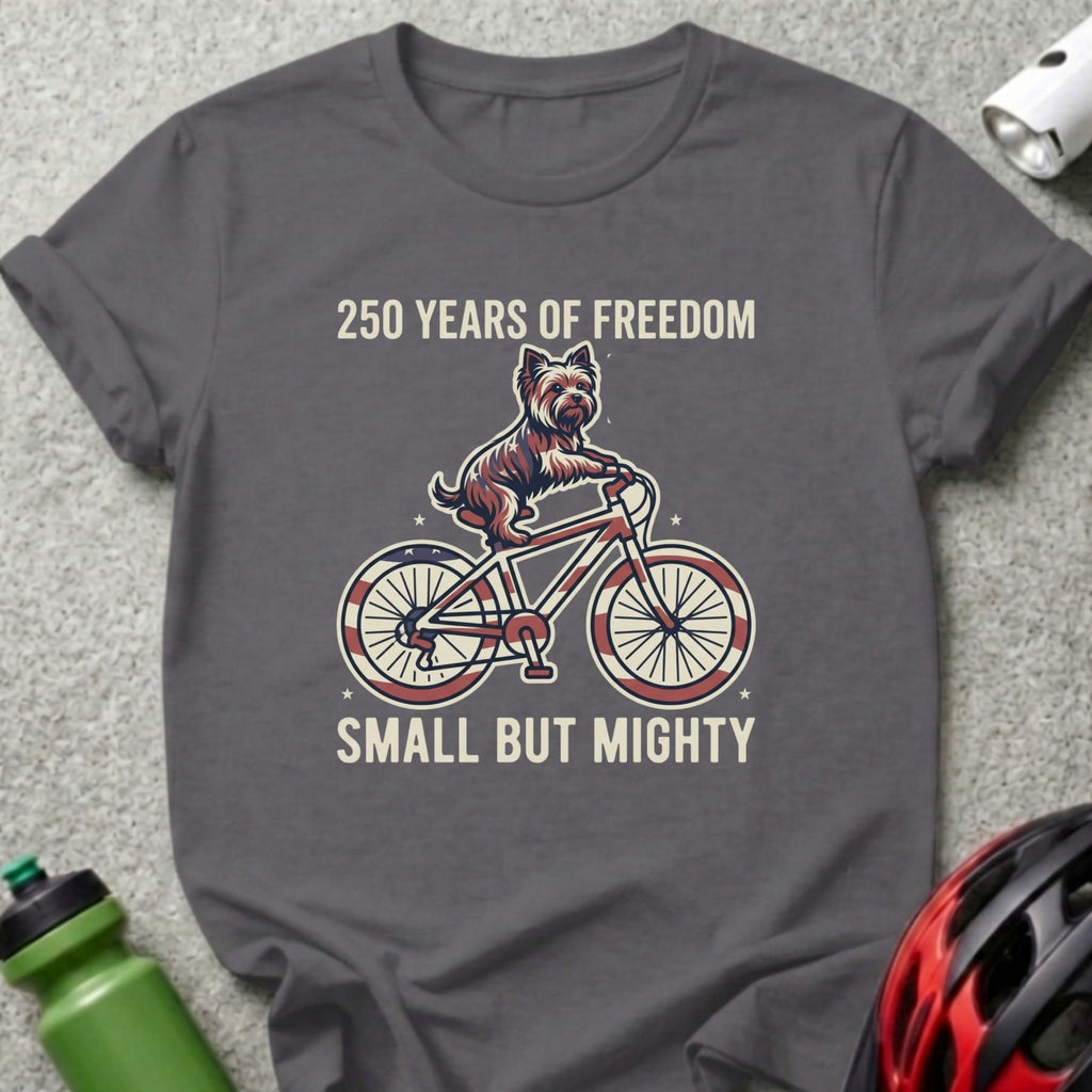 Dog on a bicycle with American flag spokes, "250 Years of Freedom, Small But Mighty".