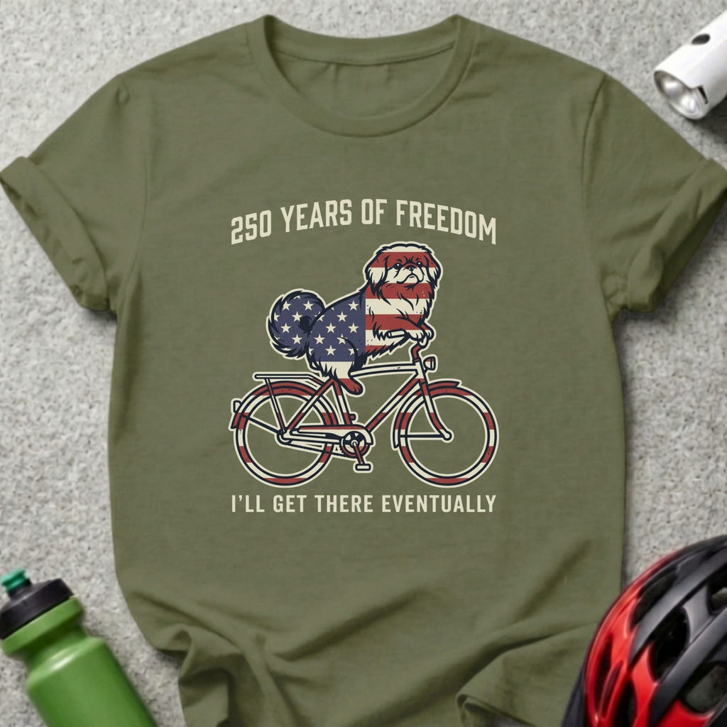 Dog wearing American flag bandana rides bicycle with text "250 Years of Freedom."