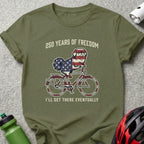 Dog wearing American flag bandana rides bicycle with text "250 Years of Freedom."