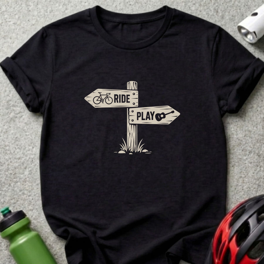 A black t-shirt printed with a signpost graphic featuring the words "RIDE" and "PLAY".