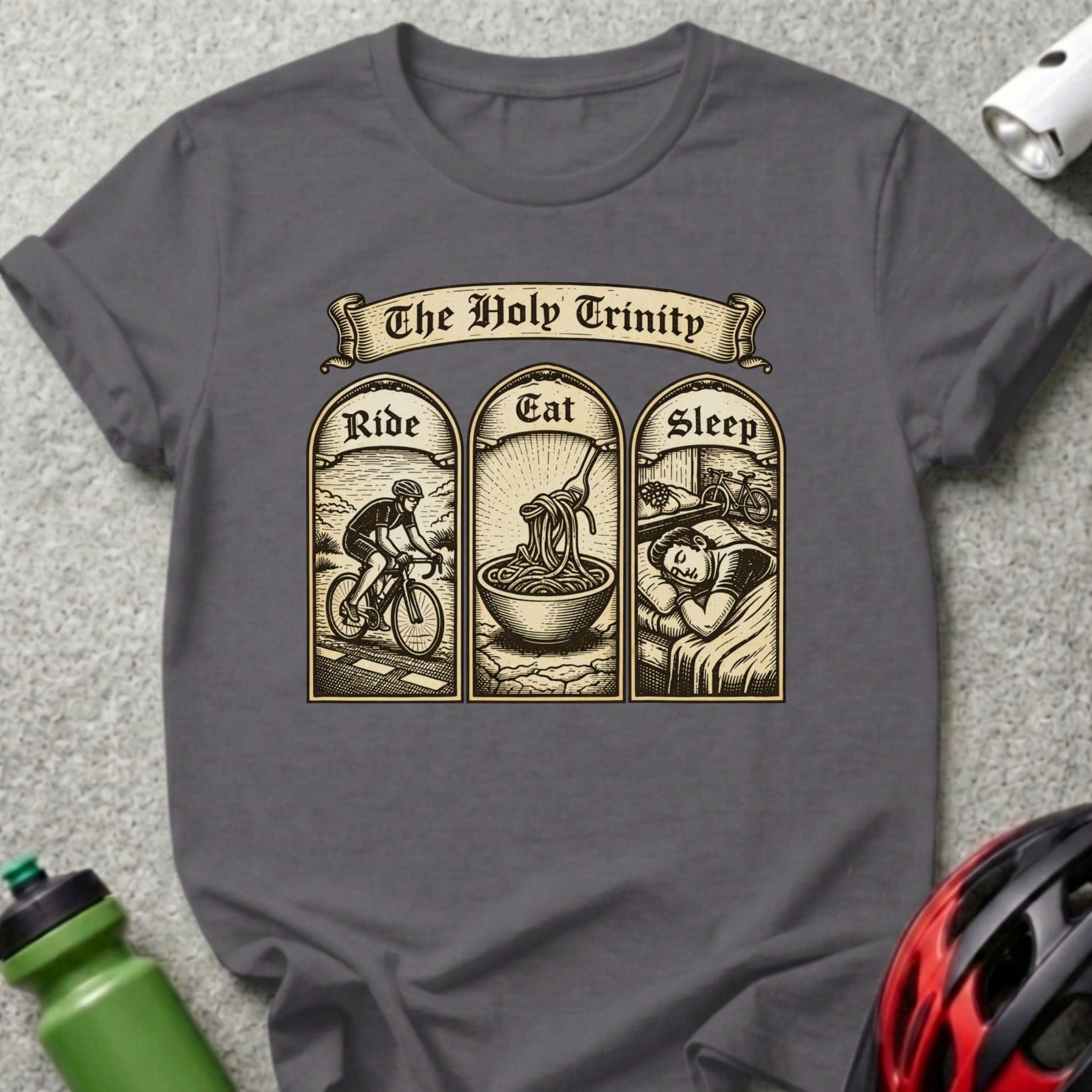 T-shirt with "The Holy Trinity" text above three panels: biking, eating pasta, sleeping.