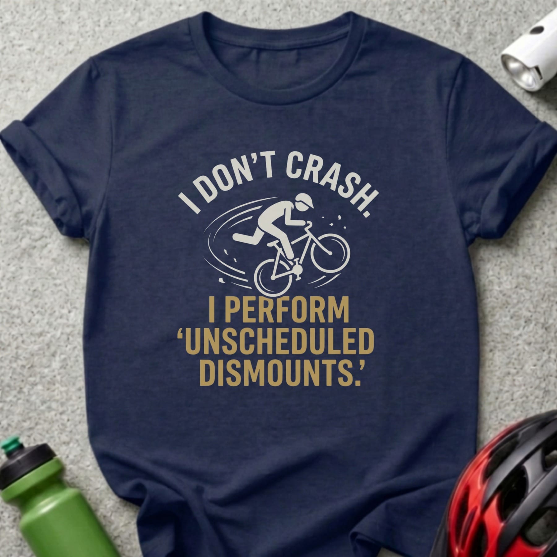 Navy t-shirt with text "I DON'T CRASH. I PERFORM 'UNSCHEDULED DISMOUNTS.'"