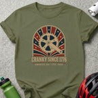 Olive t-shirt with "CRANKY SINCE 1776 AMERICA 250 1776 - 2026" graphic.