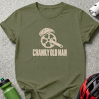 Olive green t-shirt with a cream-colored graphic of a bicycle chainring wearing a flat cap, featuring the text CRANKY OLD MAN.