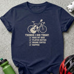 Navy blue t-shirt featuring a graphic of a bicycle and guitar with checkboxes and text.