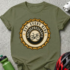 Green t-shirt with a circular design of a bicycle and "EST. EVERY RIDE ANTIDEPRESSANTS".