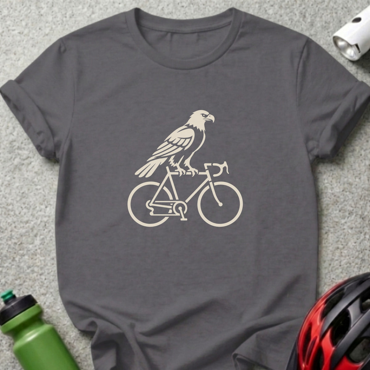 A dark gray t-shirt with a cream-colored graphic of an eagle perched on a bicycle.
