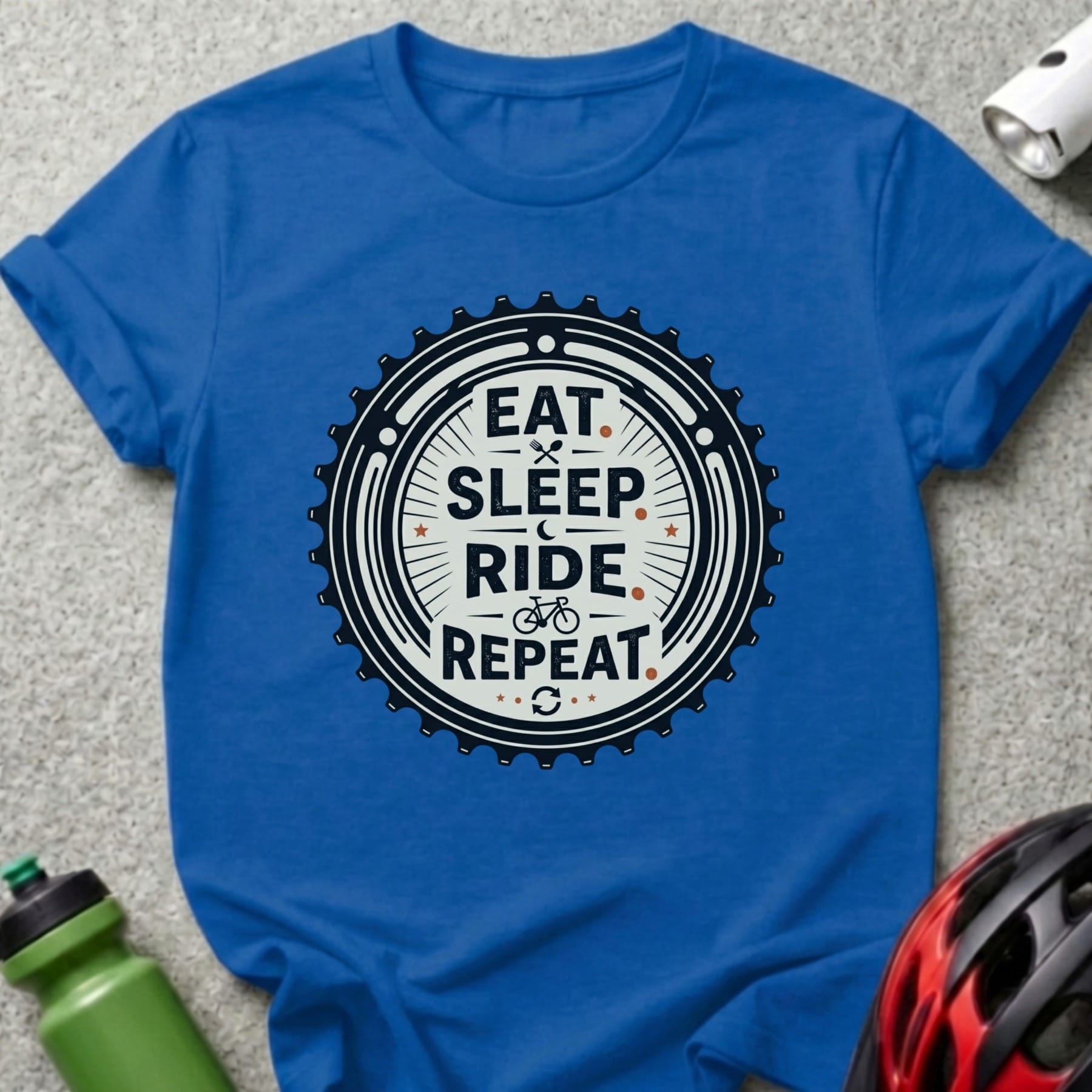Blue t-shirt with "Eat Sleep Ride Repeat" graphic on a bicycle gear.