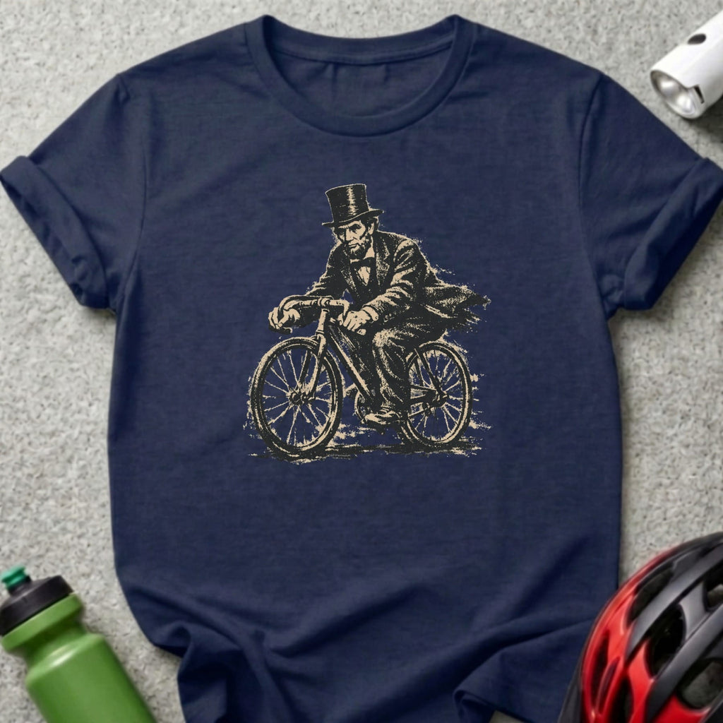 Abraham Lincoln on a bicycle, vintage illustration on a navy t-shirt.