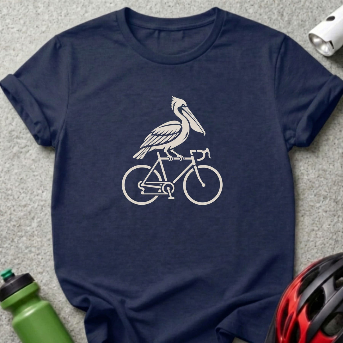 A dark blue t-shirt features a white graphic of a pelican riding a bicycle.