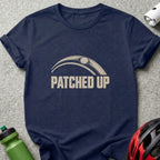 Navy blue t-shirt featuring a graphic with a bicycle tire and the text Patched Up.