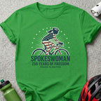 Green t-shirt with "Spokeswoman 250 Years of Freedom Power in Motion" text.