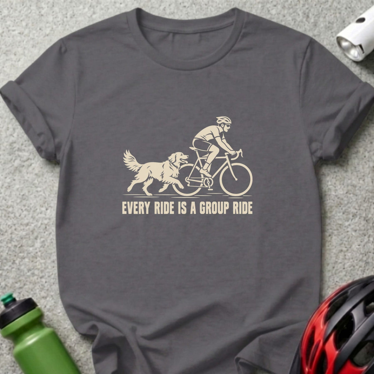 Dark gray t-shirt with a cream graphic of a cyclist and dog, featuring the text every ride is a group ride.