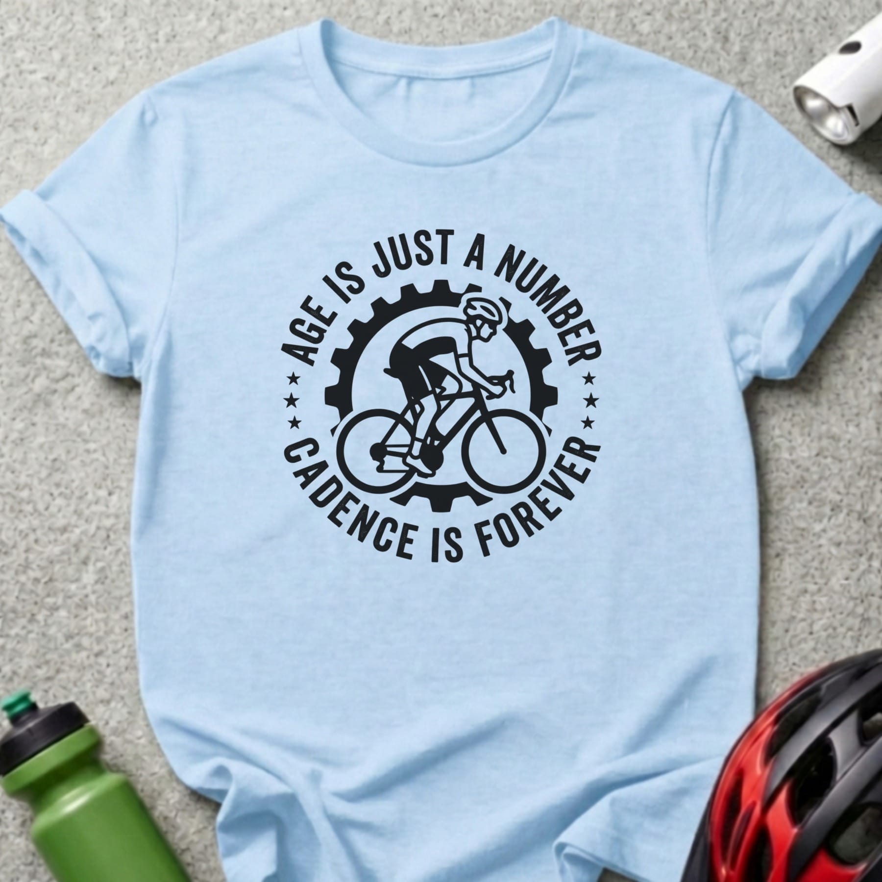 Light blue t-shirt with "Age is just a number cadence is forever" cycling graphic.
