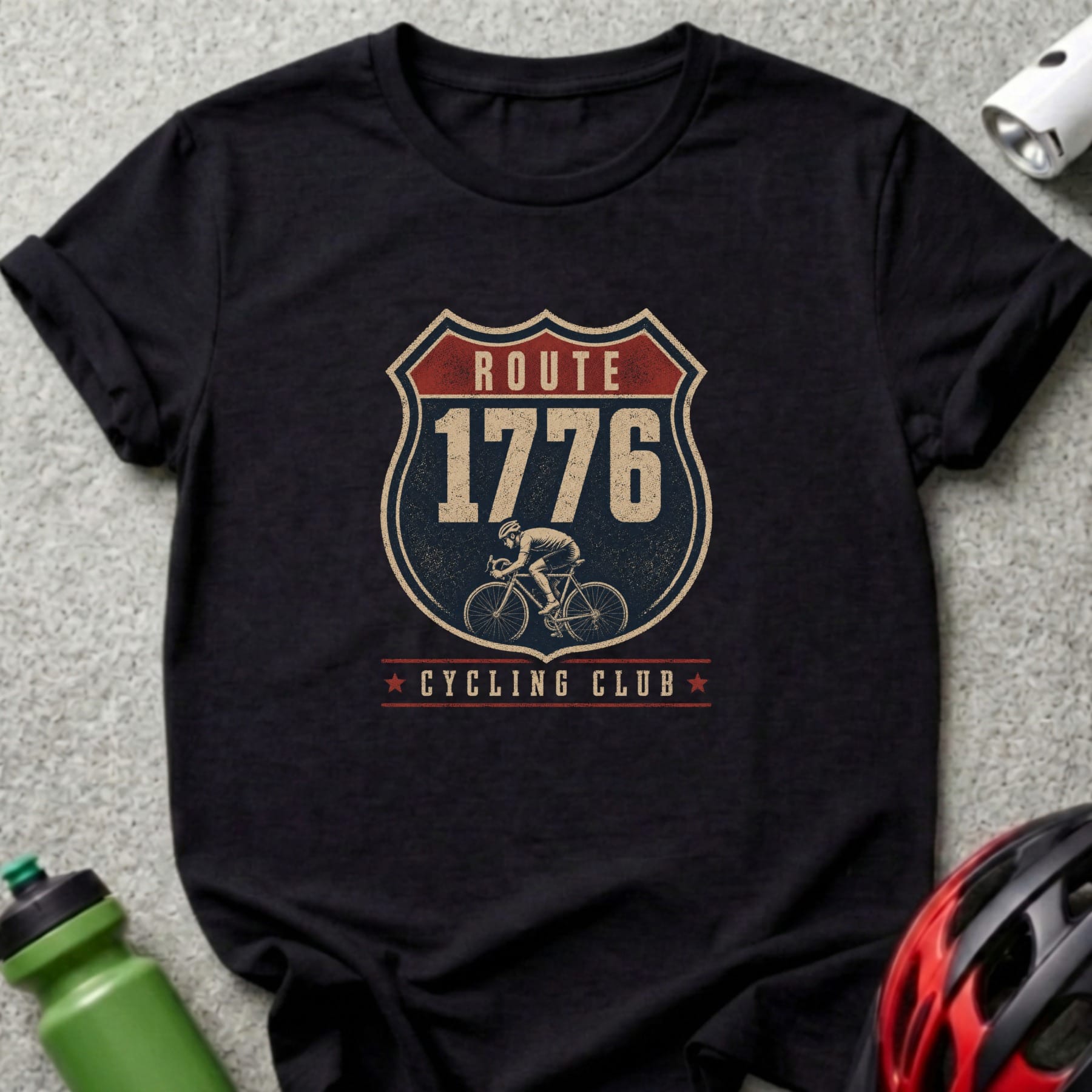 Black t-shirt featuring a shield graphic with "Route 1776 Cycling Club" and a cyclist.