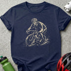 T-shirt with sketch of a cyclist wearing a helmet riding through water.