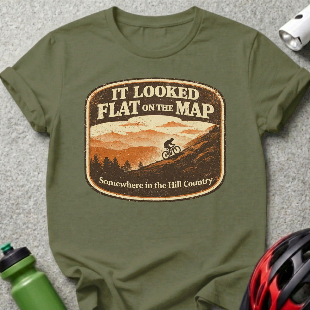 Olive green t-shirt with "It looked flat on the map" graphic featuring a cyclist in hills.