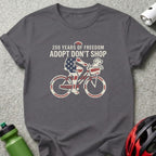 T-shirt graphic of person on bicycle with dog, "250 Years of Freedom Adopt Don't Shop".