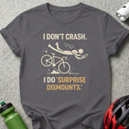 Dark grey t-shirt with "I DON'T CRASH. I DO 'SURPRISE DISMOUNTS.'" and bicycle graphic.