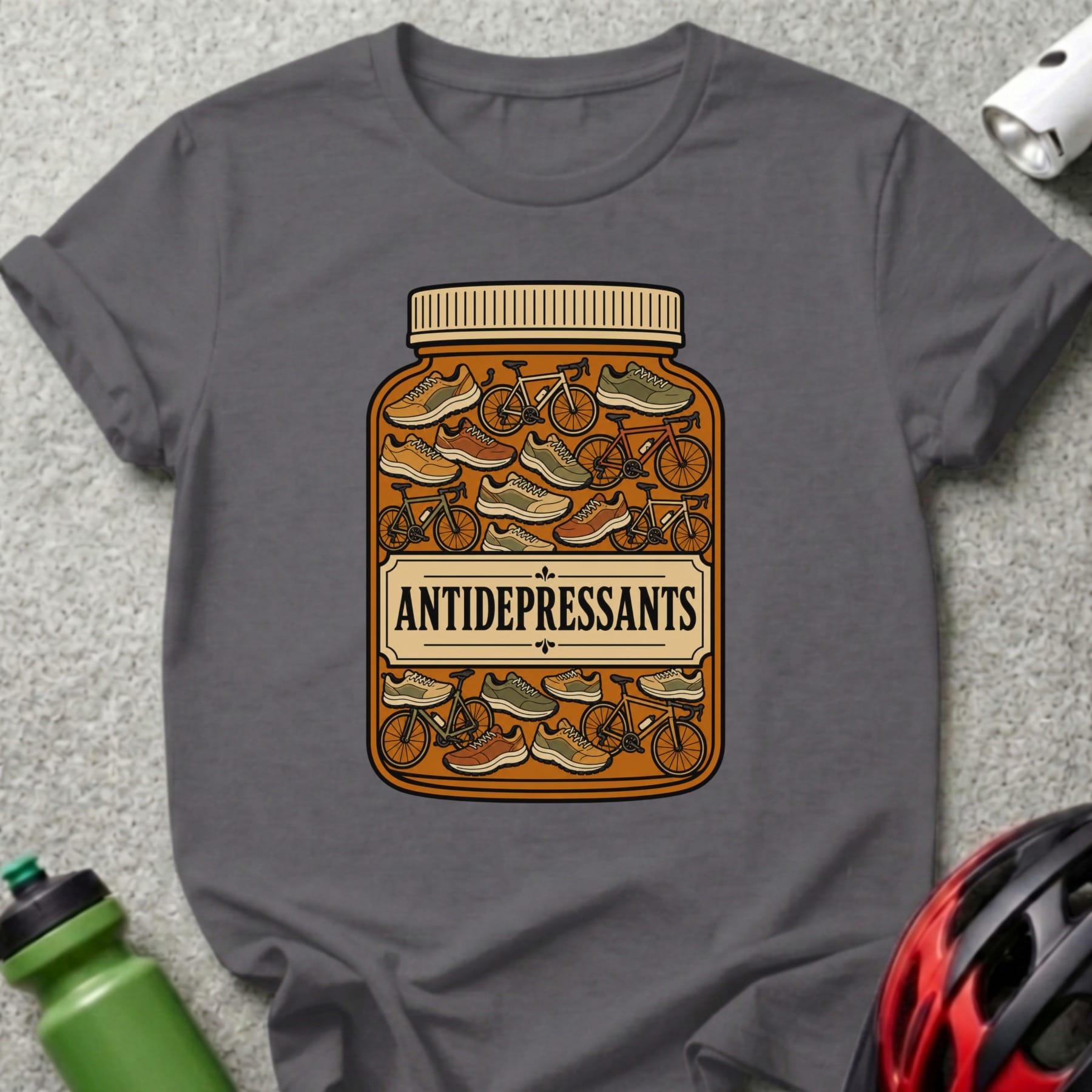 Gray t-shirt with "ANTIDEPRESSANTS" label on a pill bottle filled with bicycles and shoes.