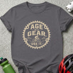 T-shirt with text "Age Is A Gear. Use It." and bicycle graphic.