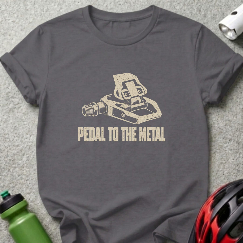 A dark gray t-shirt featuring a bicycle pedal graphic and the text PEDAL TO THE METAL.