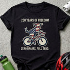 Black t-shirt with dog on bicycle, American flag design, and text.
