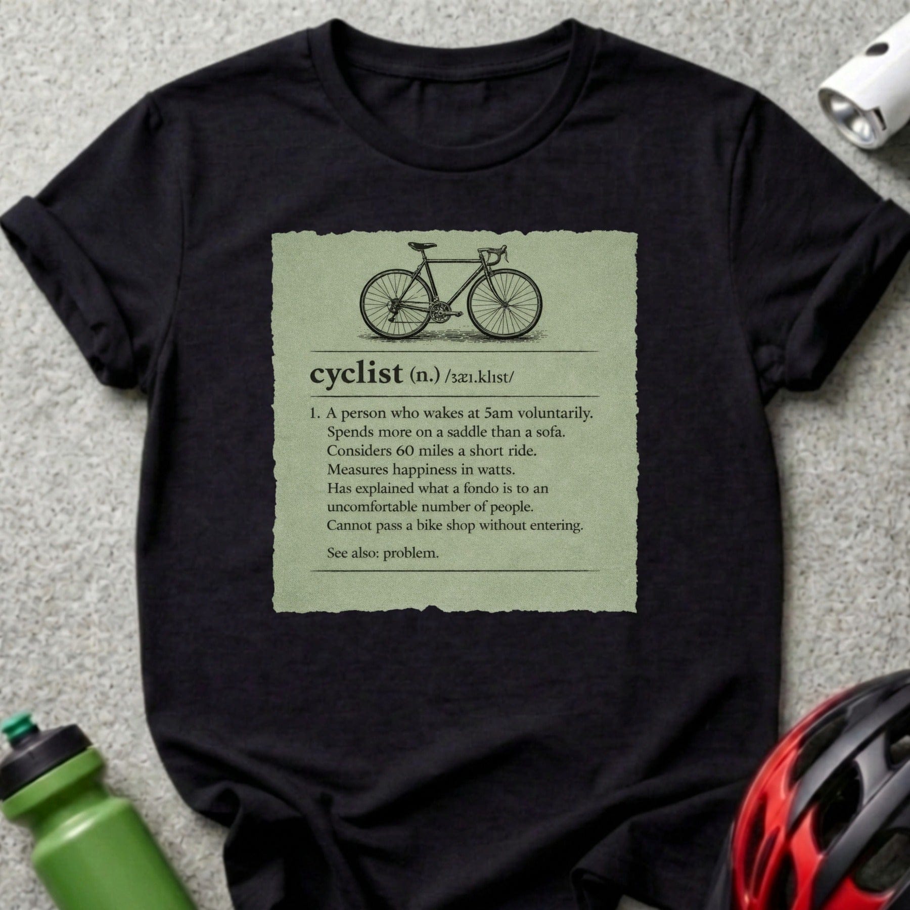 T-shirt with definition of "cyclist" on green textured background.
