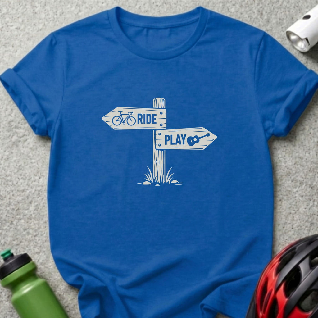 Blue short-sleeve t-shirt with a white graphic of a wooden signpost reading RIDE and PLAY.
