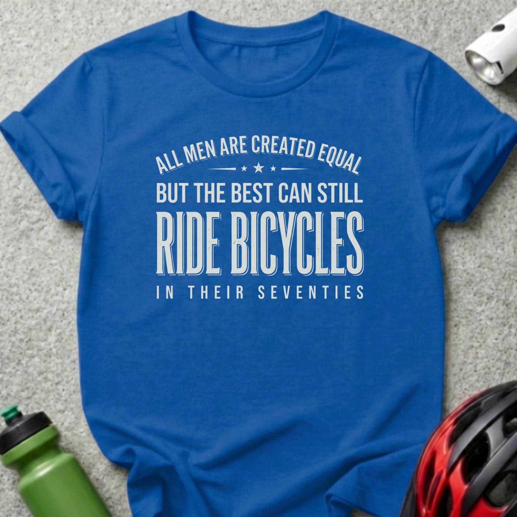 Blue t-shirt with text "All men are created equal but the best can still ride bicycles in their seventies."