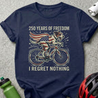 Dog in American flag cape rides bicycle, "250 Years of Freedom I Regret Nothing."
