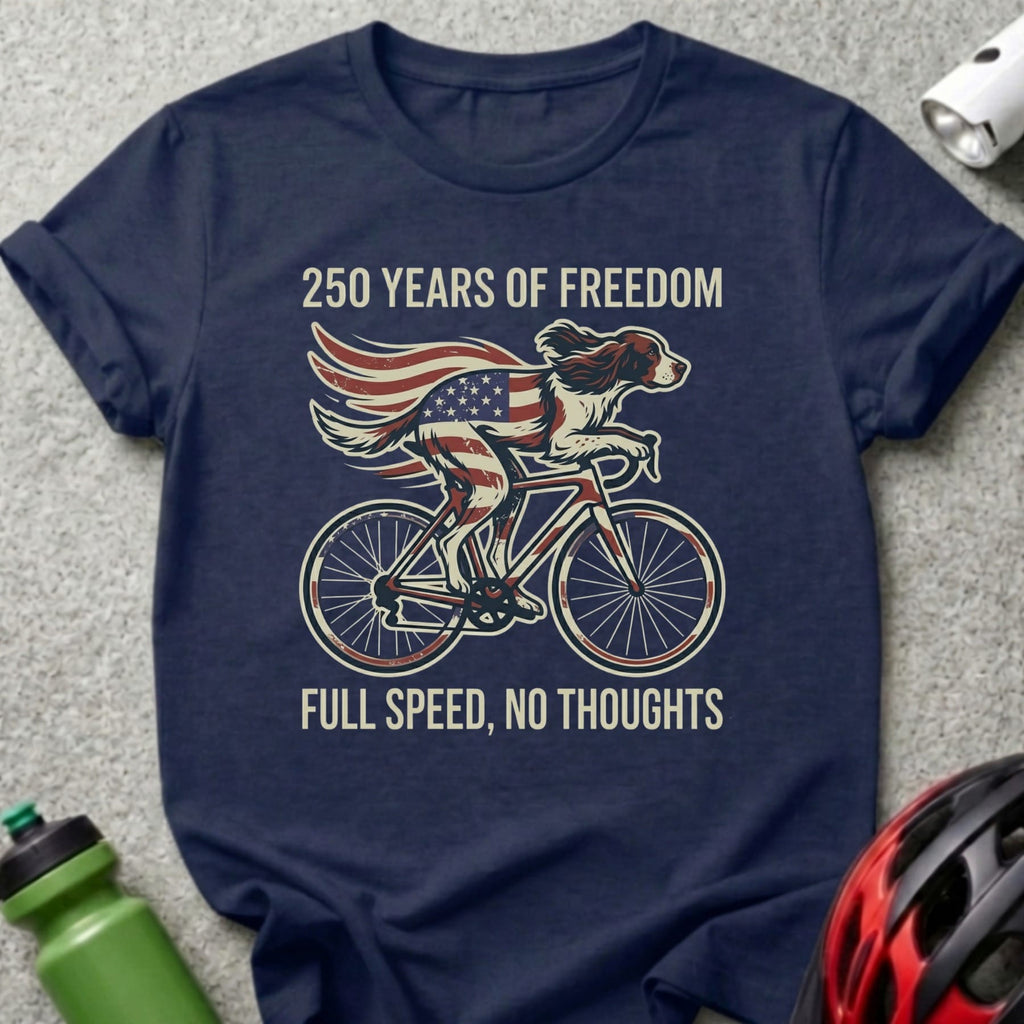 Navy t-shirt with dog on bicycle, American flag, and text "250 Years of Freedom, Full Speed, No Thoughts".