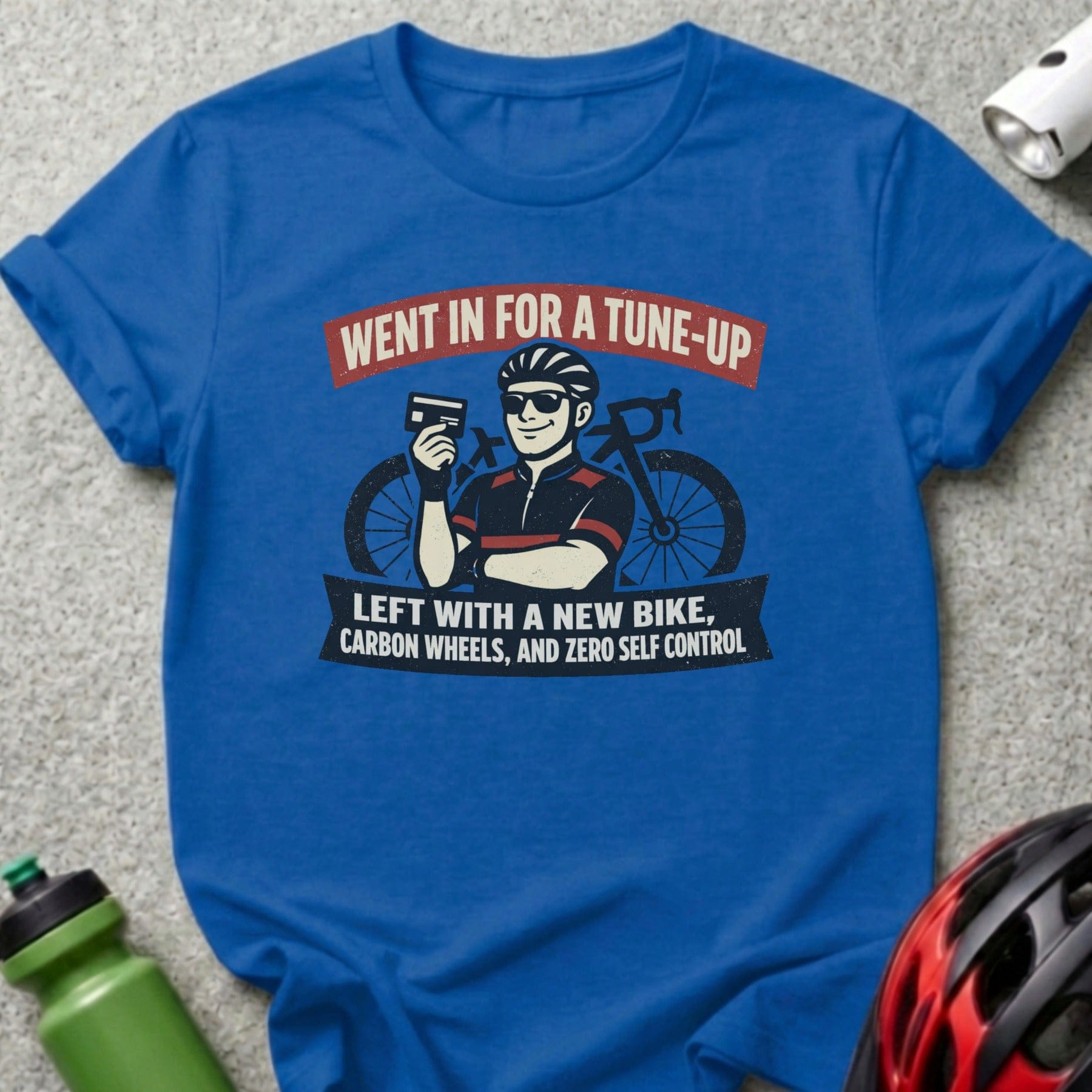 Blue t-shirt with cyclist graphic and text about new bike, carbon wheels.