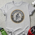 Spokeswoman logo with cyclist on bicycle within gear and stars.
