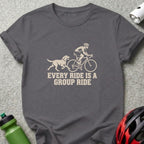 Charcoal t-shirt featuring a cream-colored graphic of a dog running behind a cyclist with the text EVERY RIDE IS A GROUP RIDE.