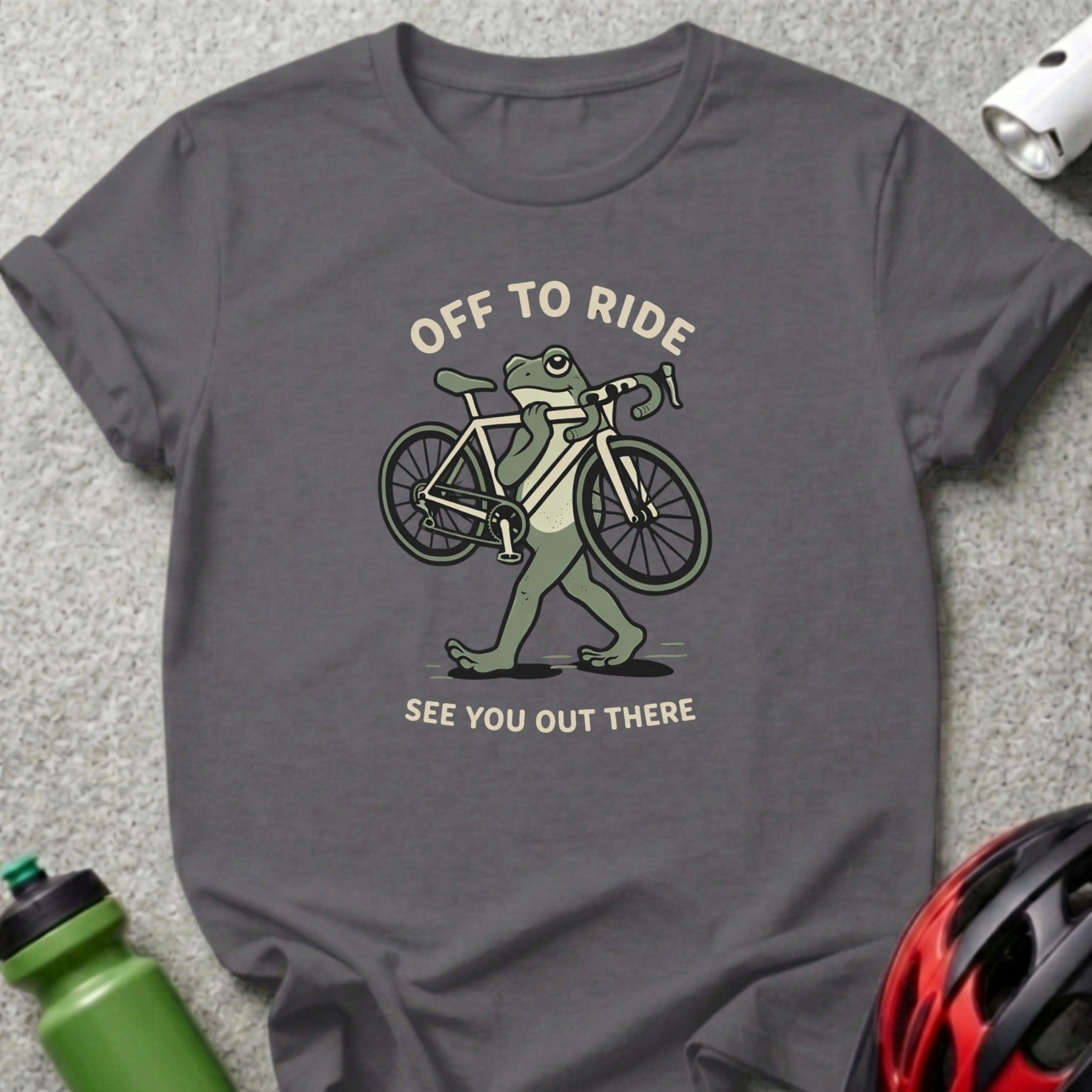 Grey t-shirt with cartoon frog carrying a bicycle, text "Off to Ride See You Out There".