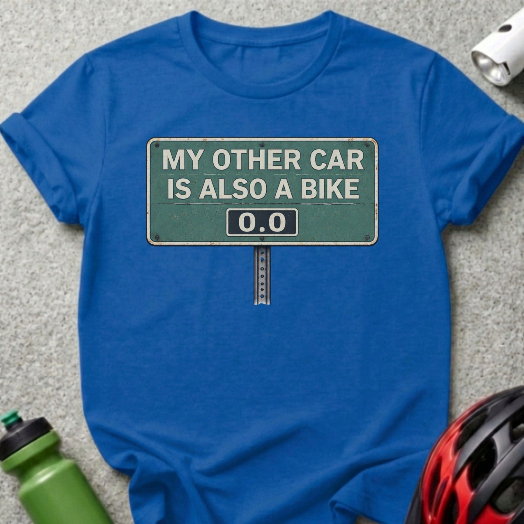 Blue t-shirt with "My other car is also a bike" sign graphic.