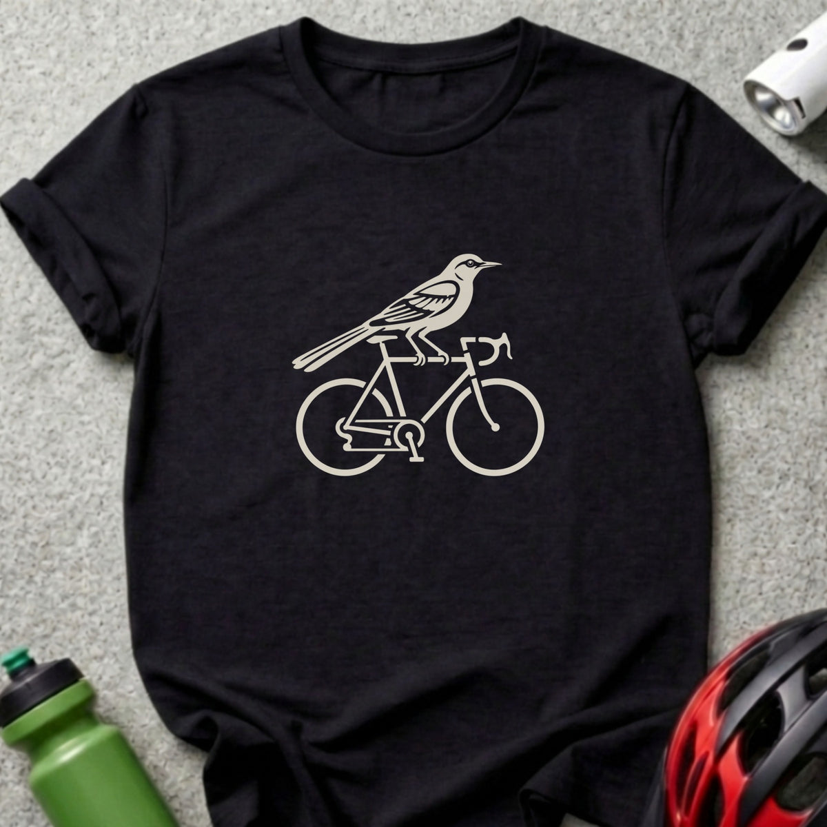 A black crewneck t-shirt featuring a beige graphic of a bird perched on a bicycle.