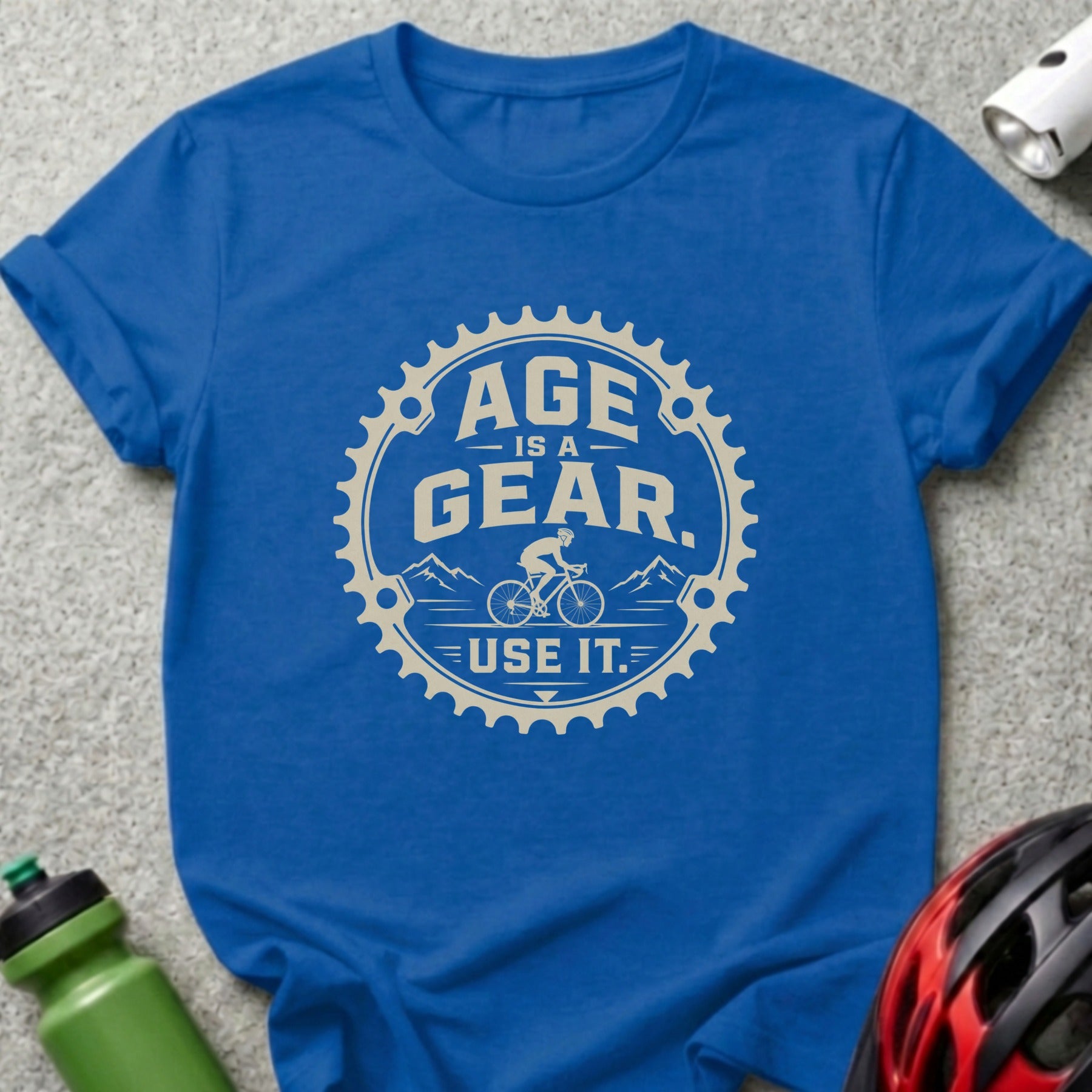 Blue t-shirt with "Age is a gear. Use it." text and cyclist graphic.