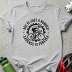 Gray t-shirt with "Age is just a number, cadence is forever" cycling graphic.