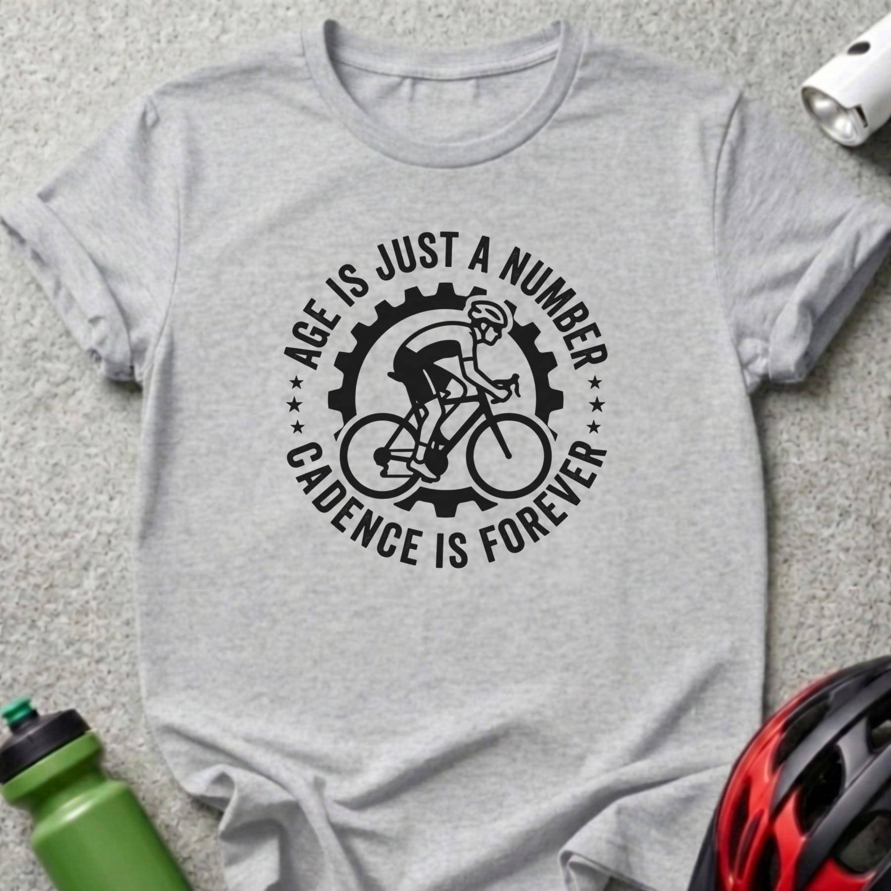 Gray t-shirt with "Age is just a number, cadence is forever" cycling graphic.