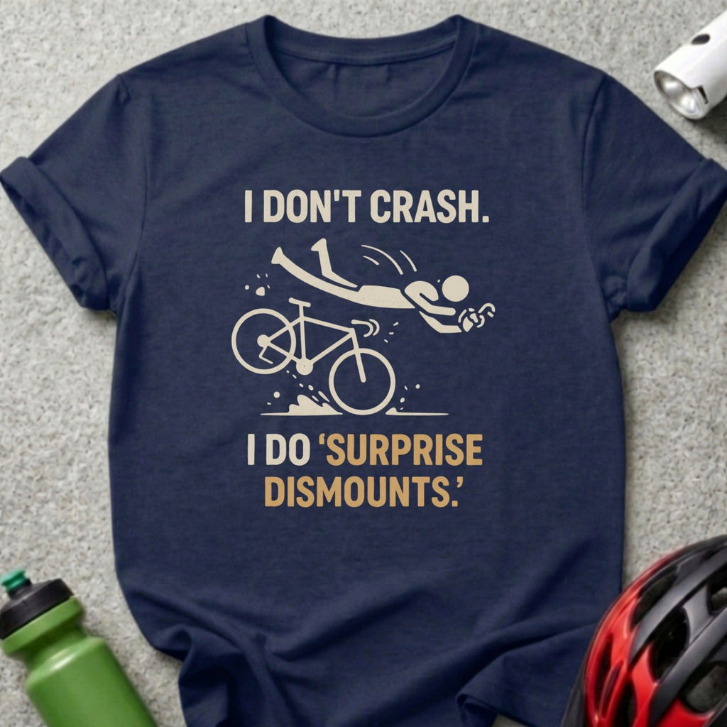 Navy t-shirt with "I DON'T CRASH. I DO 'SURPRISE DISMOUNTS.'" and cyclist graphic.